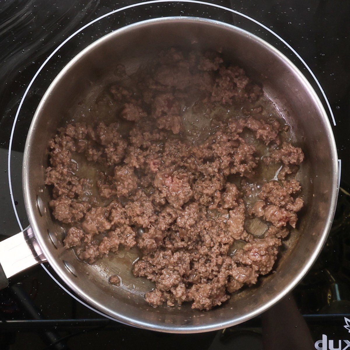 ground beef browning in a saucepan.