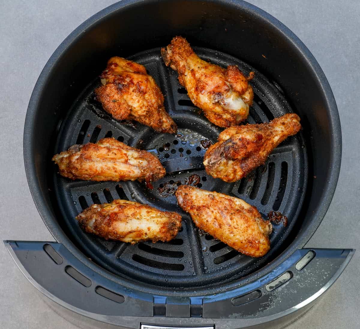 a small batch of chicken wings in an air fryer.