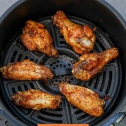 a small batch of chicken wings in an air fryer.