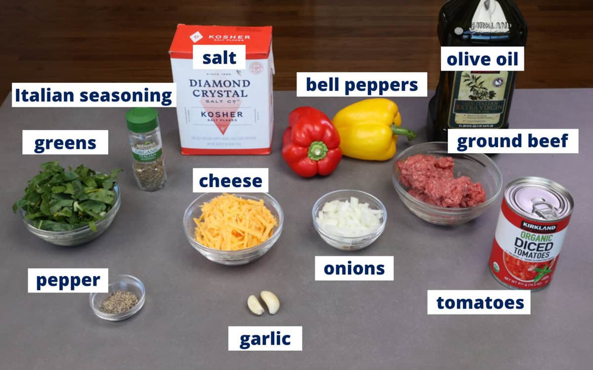 ingredients for stuffed peppers with two bell peppers on a kitchen counter.