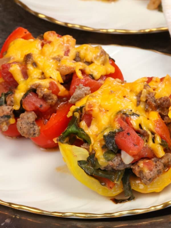 two stuffed peppers on a white plate.