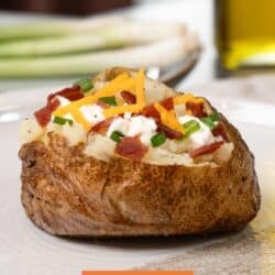a loaded baked potato on a white plate.