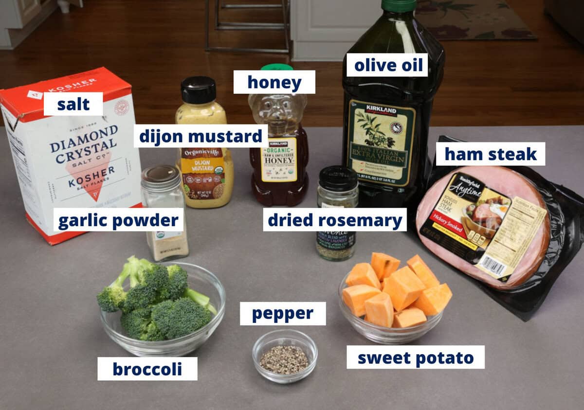ingredients for a baked ham sheet pan meal on a kitchen counter.