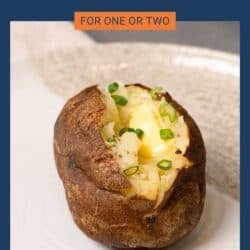 a baked potato with butter on a plate.