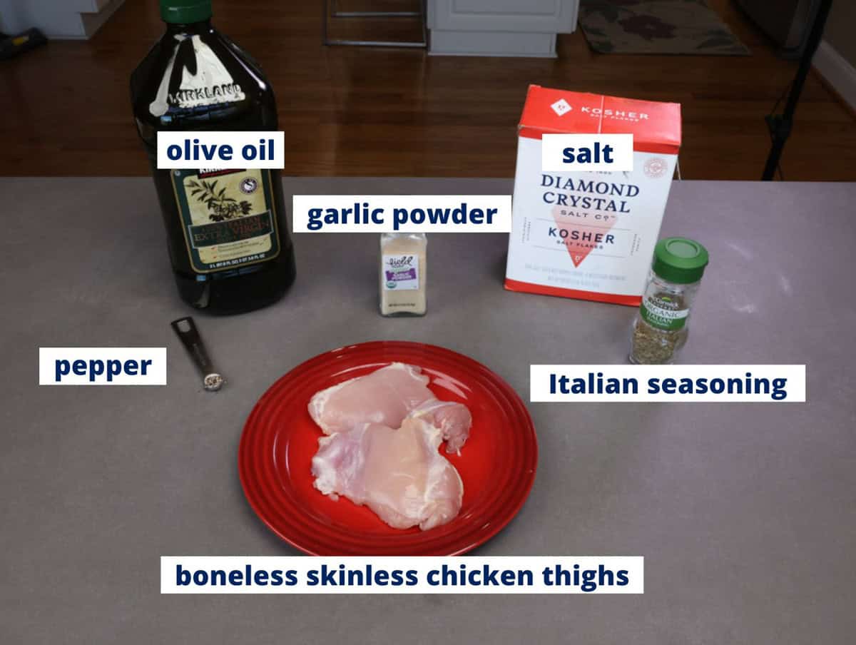 ingredients needed to bake boneless skinless chicken thighs on a kitchen counter.