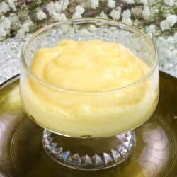 a single bowl of vanilla custard on a green plate.