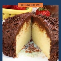 a small yellow cake topped with chocolate buttercream on a white plate.