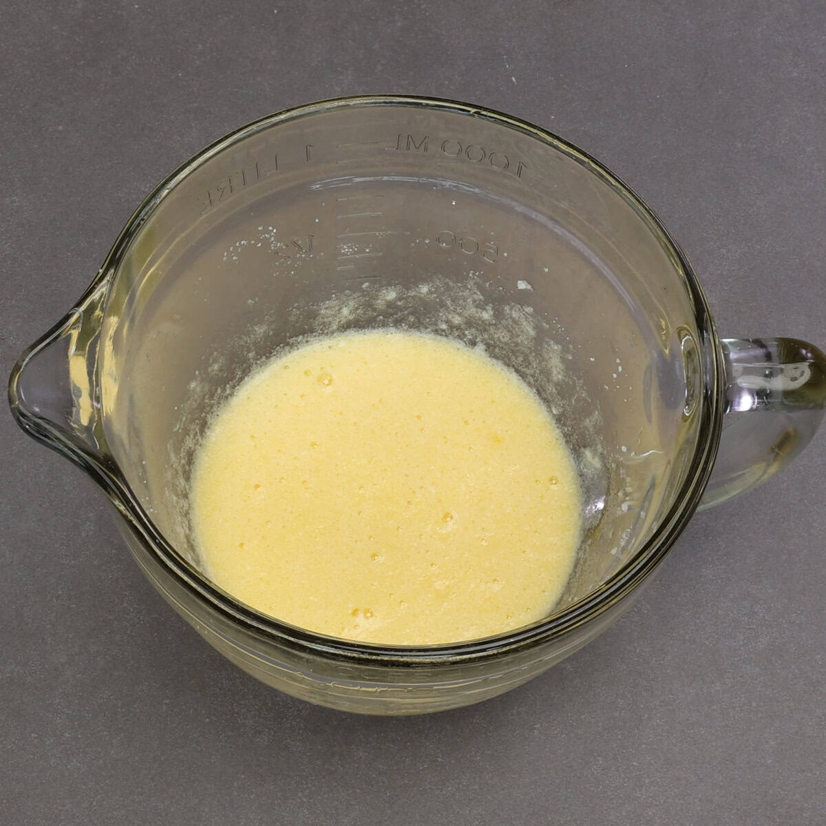 butter, sugar, egg and vanilla blended together in a mixing bowl.