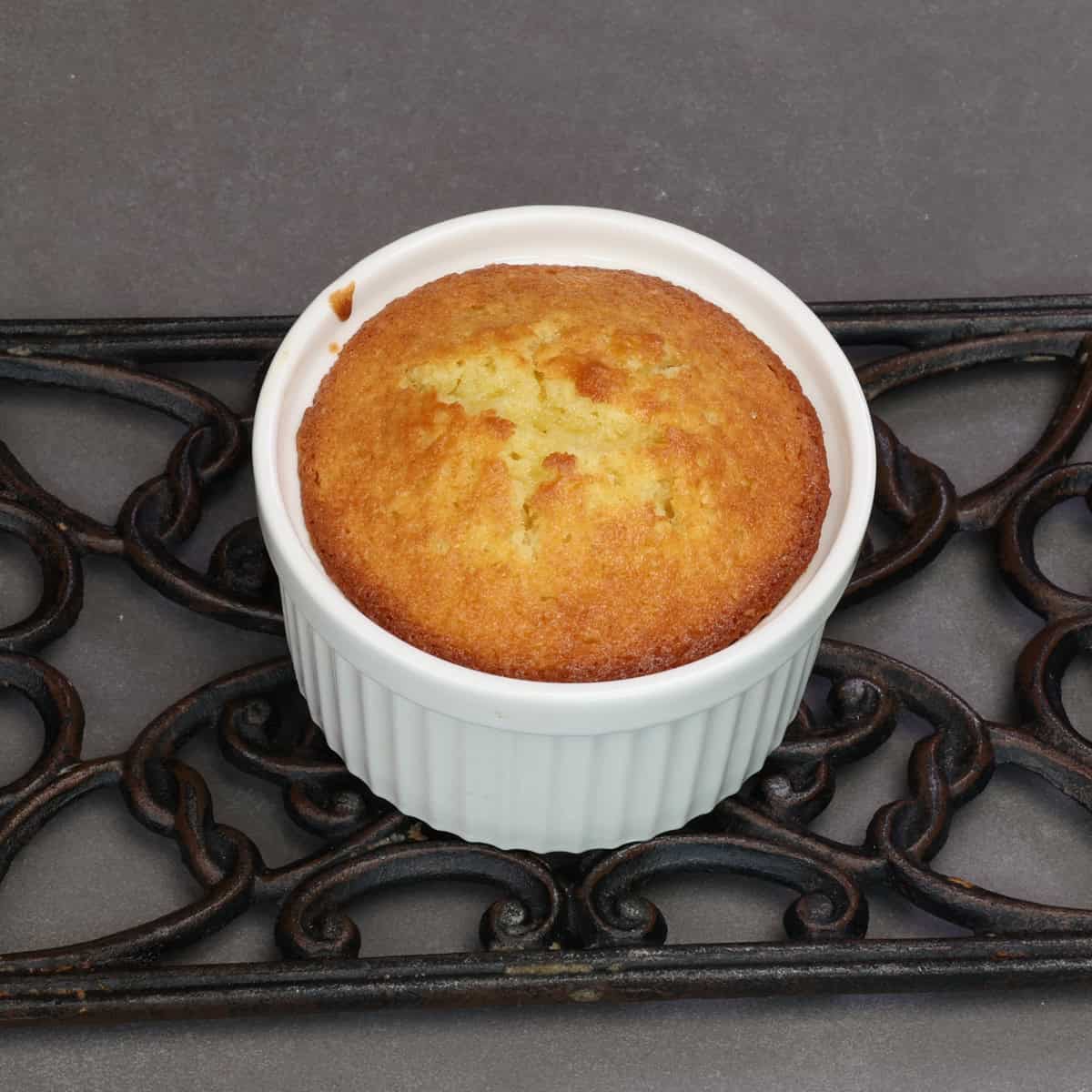 a small yellow cake cooling on a wire rack.