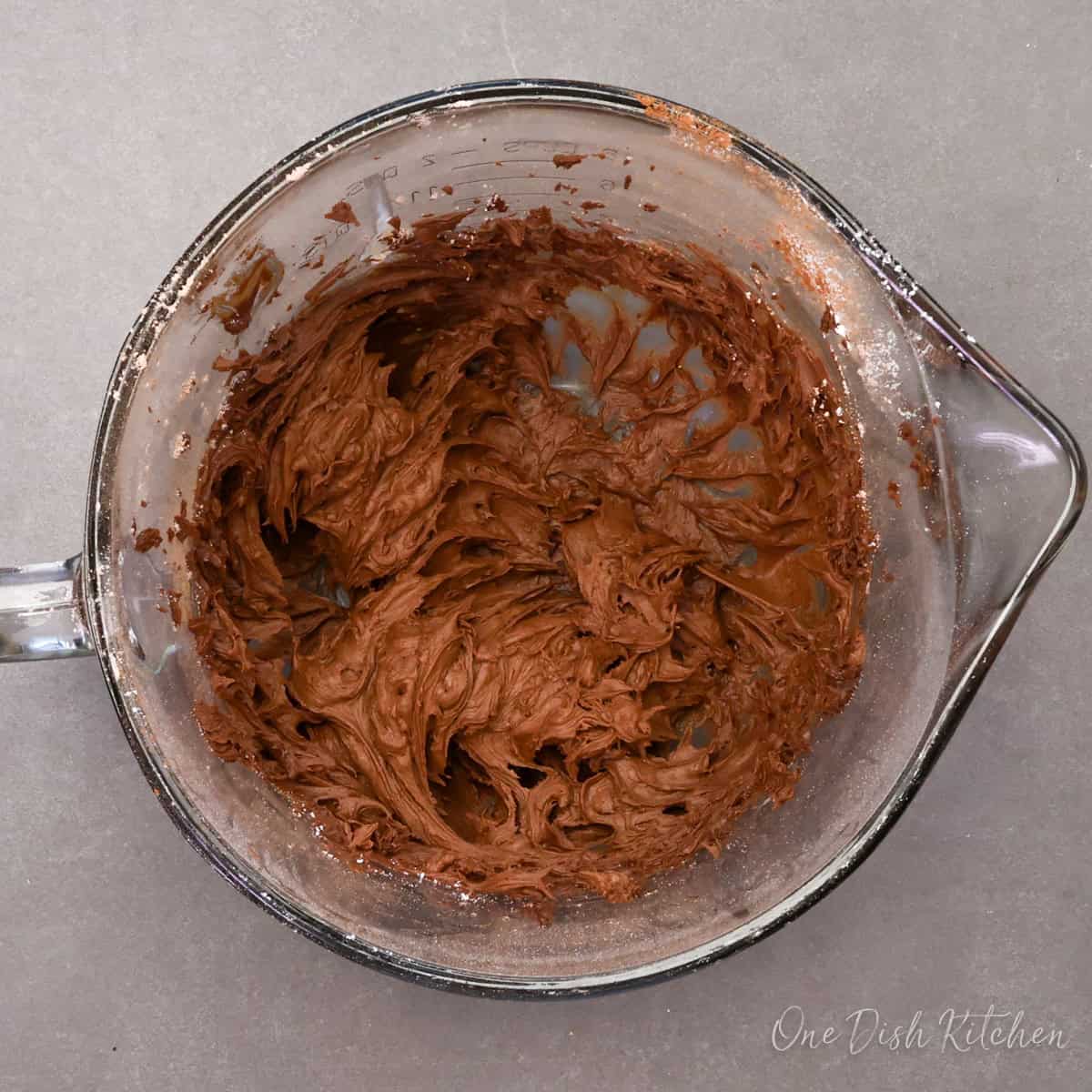 homemade chocolate frosting in a small mixing bowl.