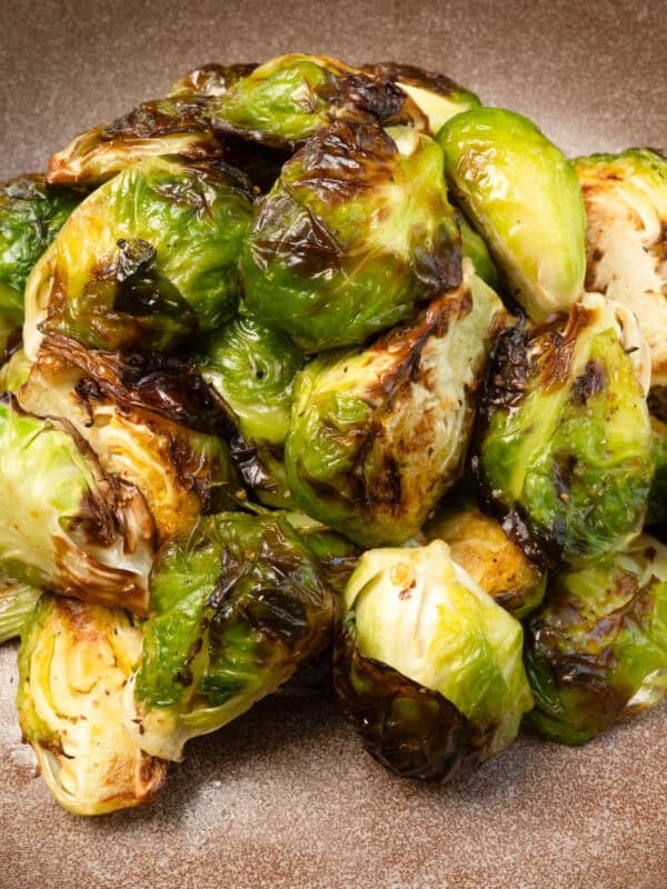 a small batch of air fryer brussels sprouts on a brown plate.