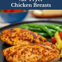 two cooked chicken breasts on a plate.