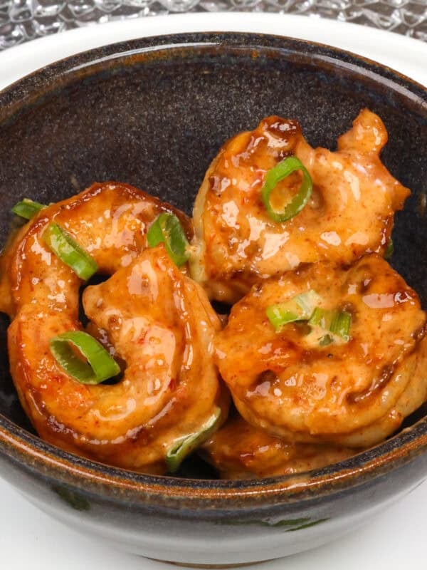 bang bang shrimp tossed in bang bang sauce in a bowl.