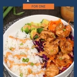 a bang bang shrimp rice bowl on a silver tray.