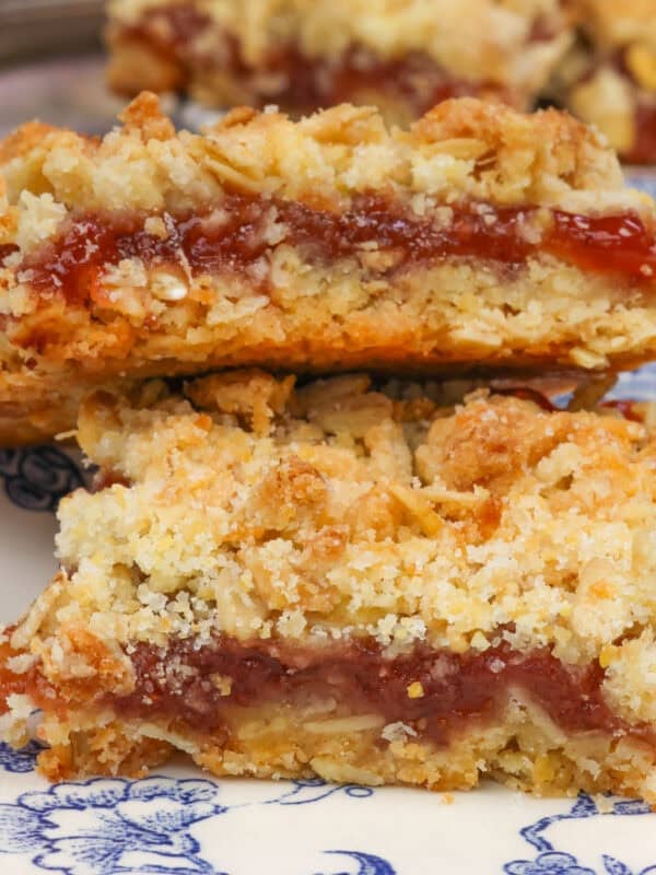 two jam-filled oatmeal bars on a blue plate.