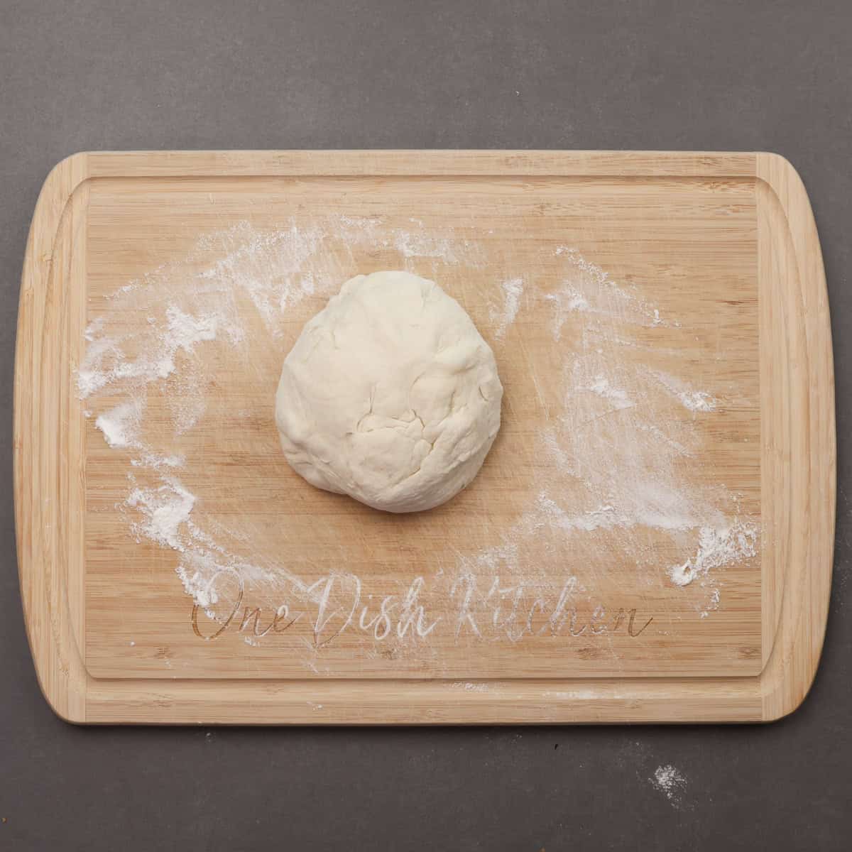 french bread dough on a cutting board.