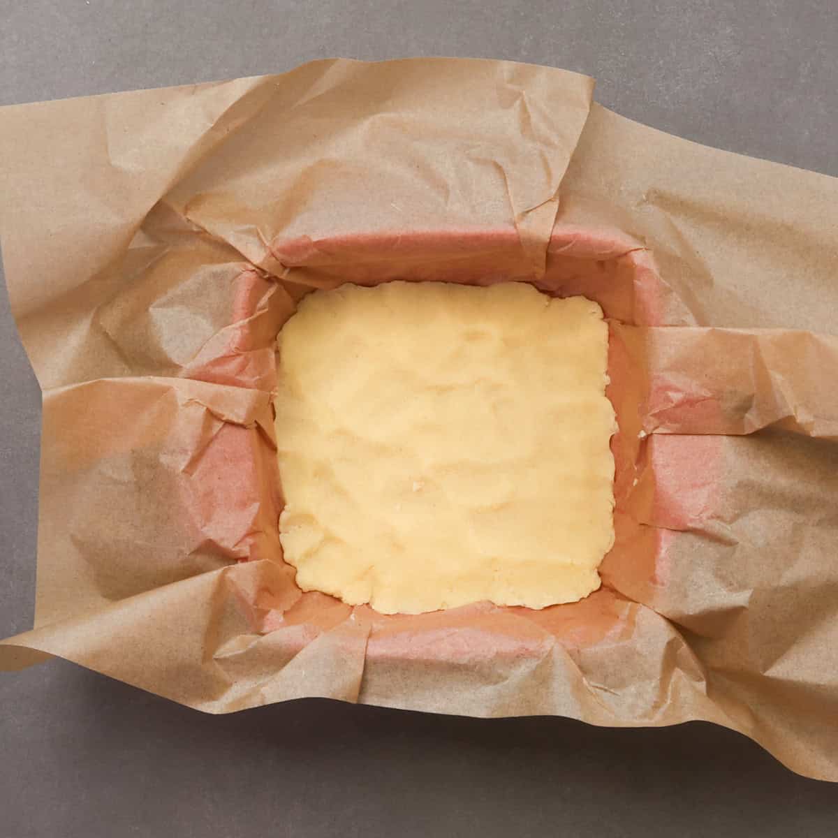 a shortbread crust for a small batch of pecan pie bars in a small baking dish.