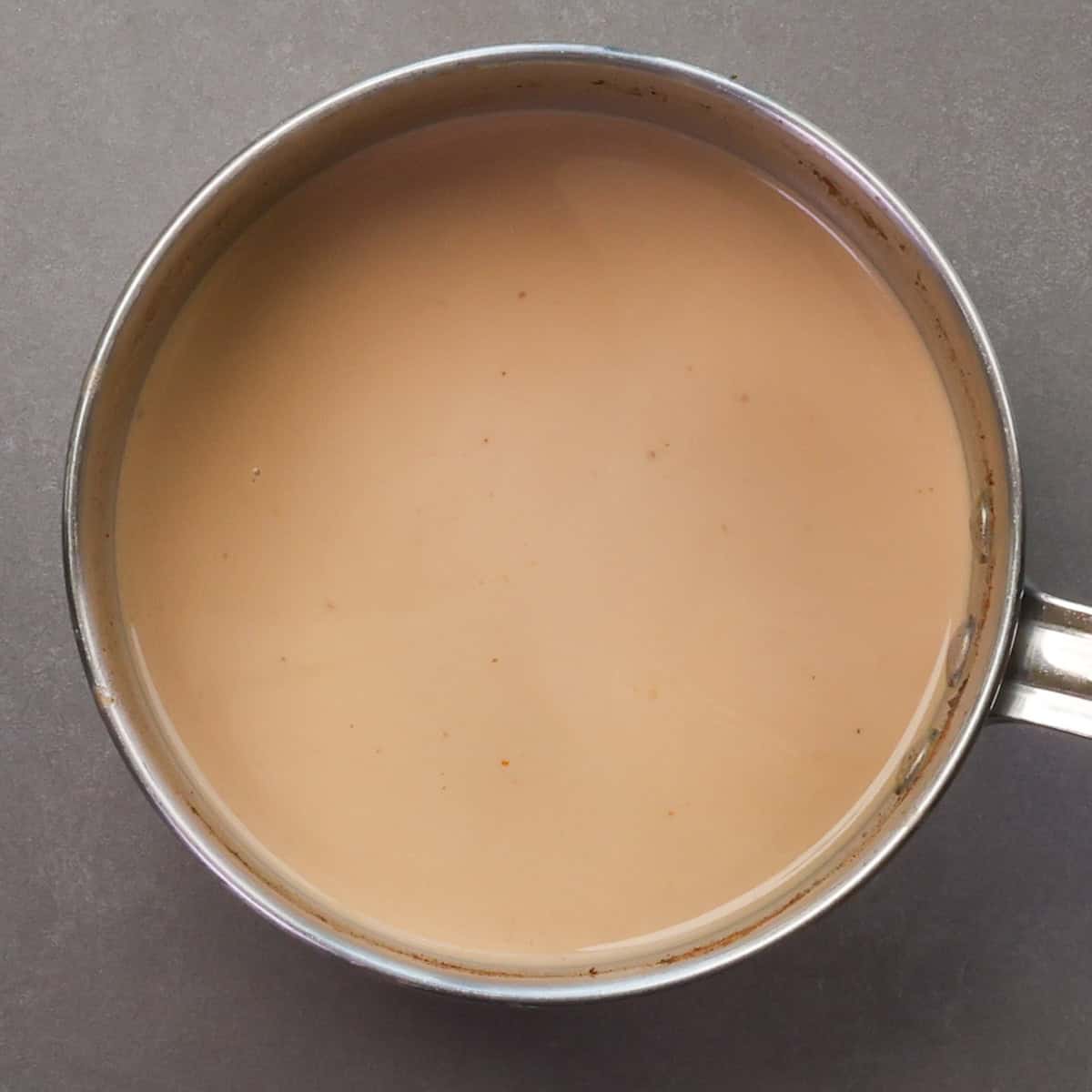 pumpkin spice coffee creamer simmering in a pot.