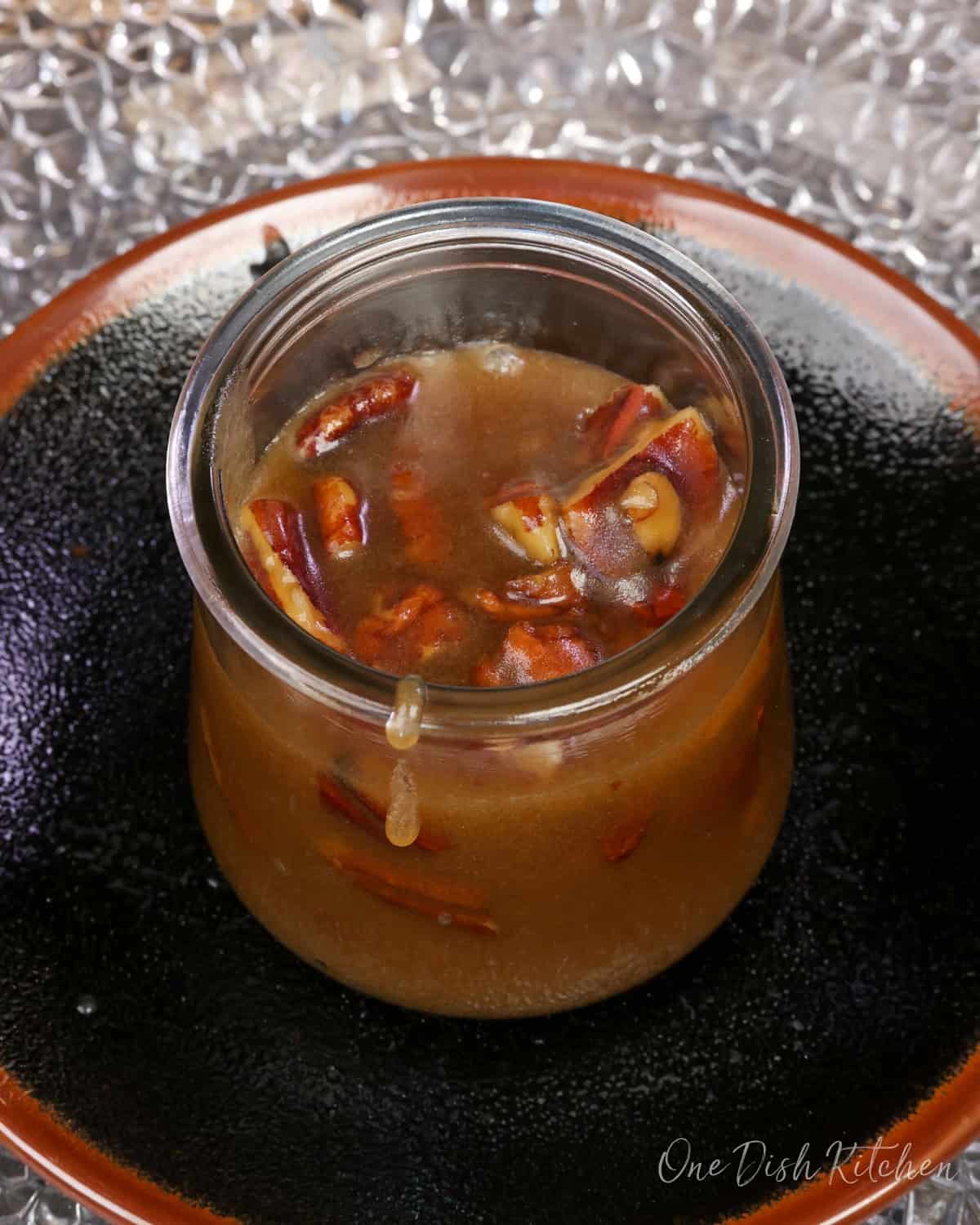 a small batch of homemade butter pecan syrup in a jar.
