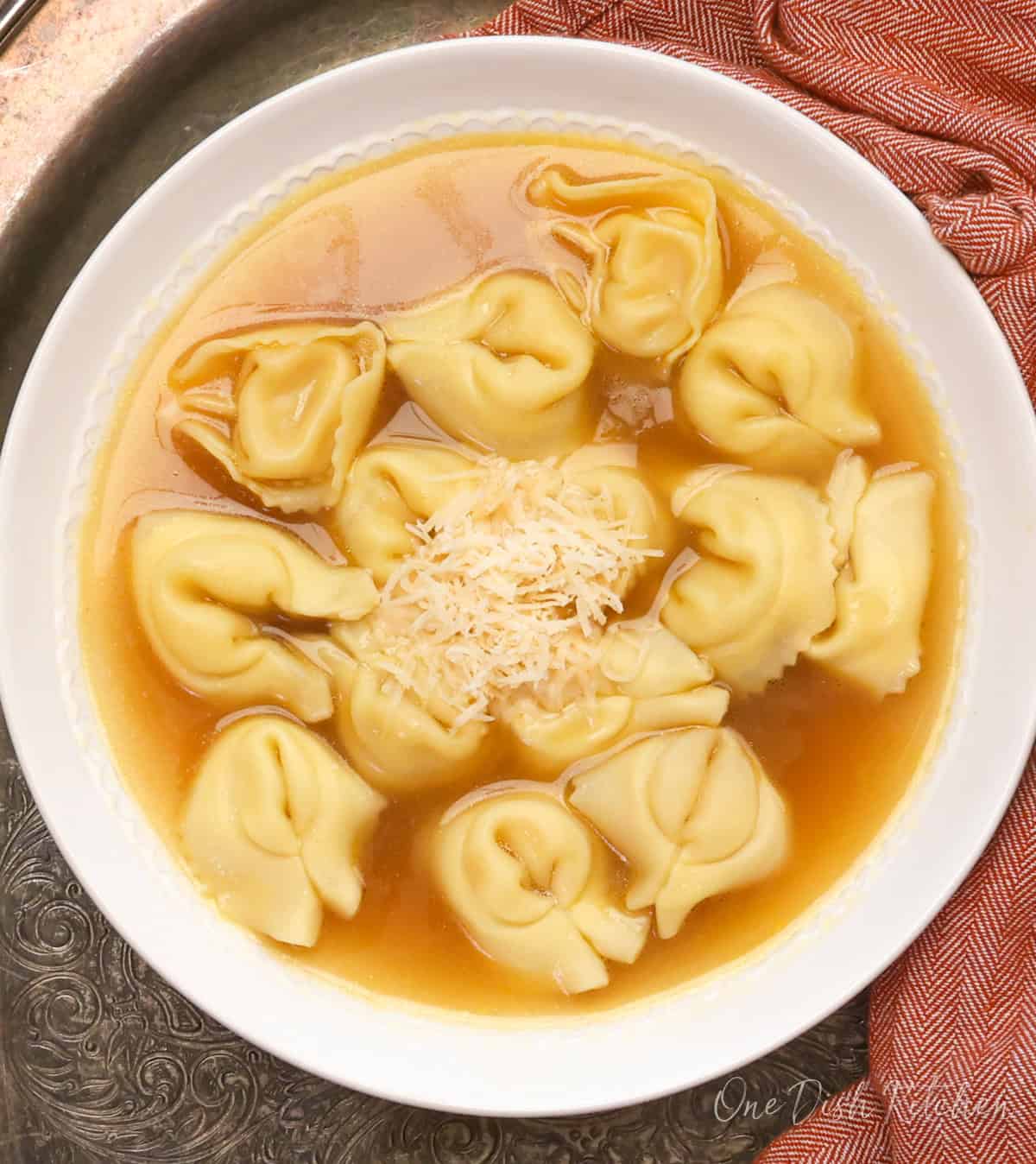 A bowl of tortellini en brodo made with store-bought chicken broth and cheese tortellini.