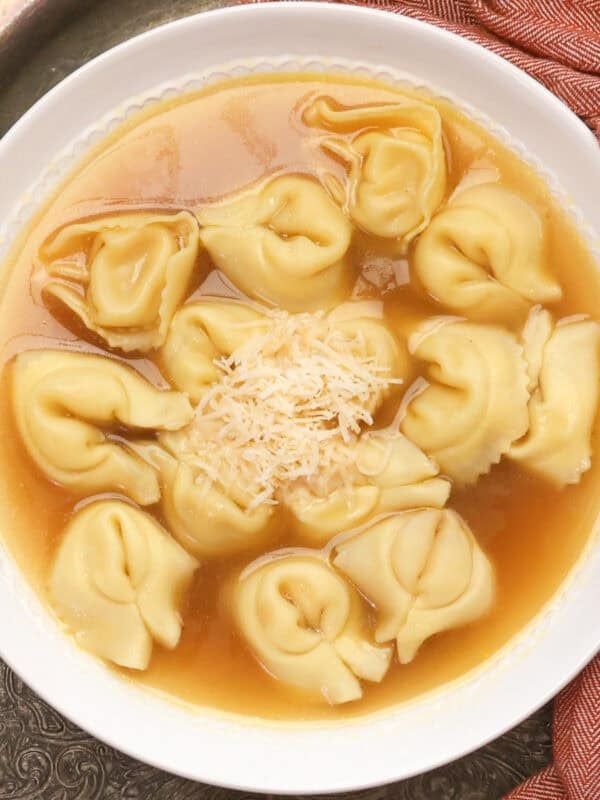 A bowl of tortellini en brodo made with store-bought chicken broth and cheese tortellini.