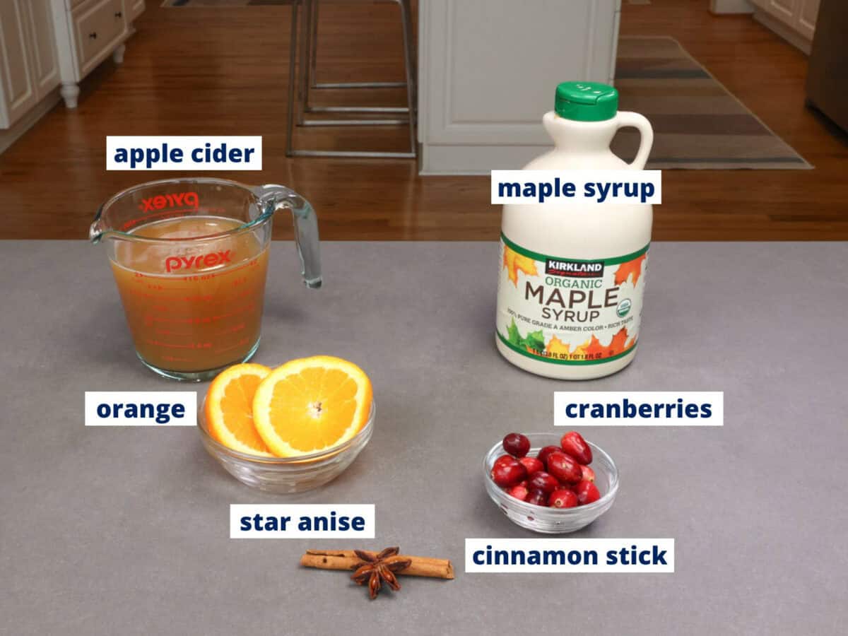 ingredients in a small batch of mulled cider on a kitchen counter.