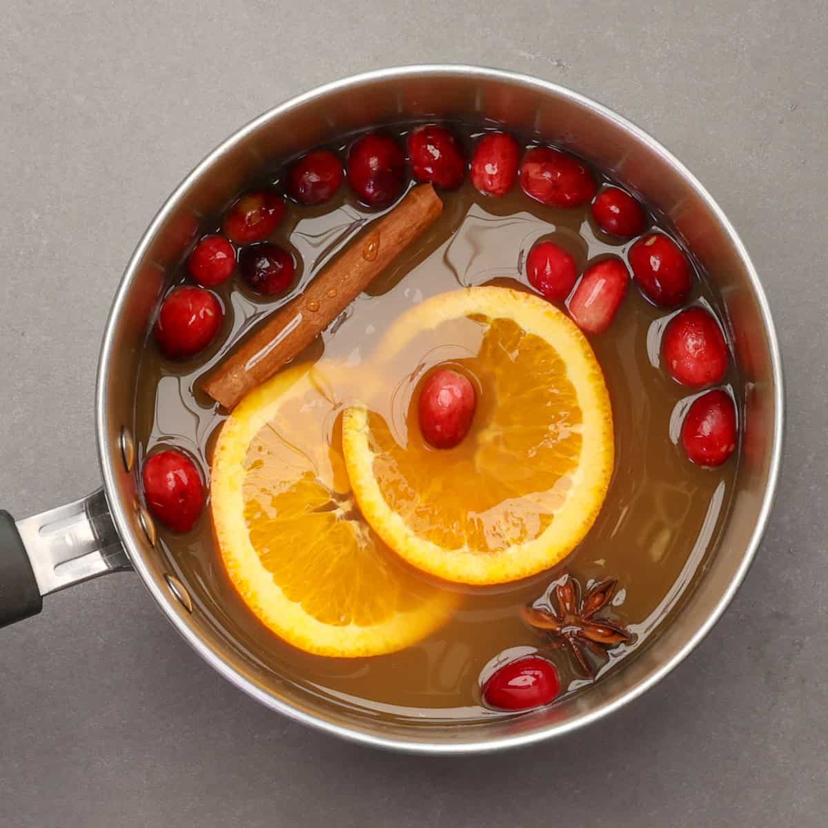 hot mulled cider in a saucepan on the stove.
