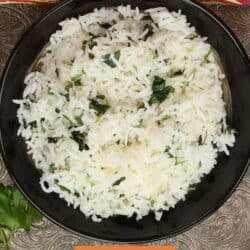a single serving of cilantro lime rice in a black bowl.