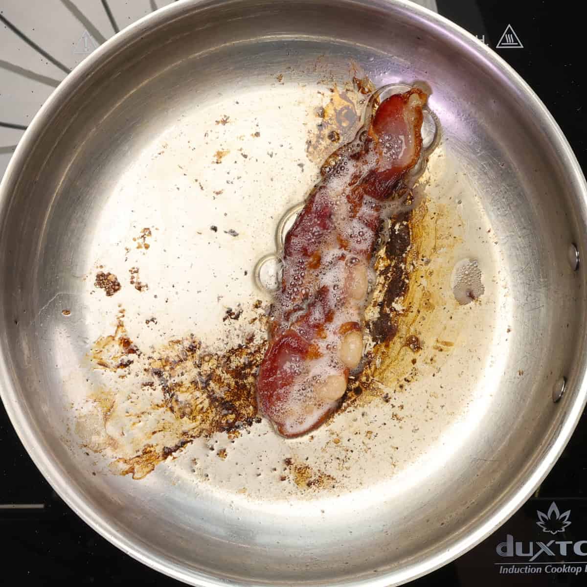 bacon cooking in a skillet.