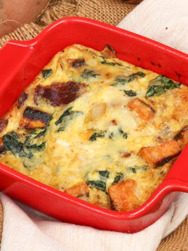 a single serving crustless sweet potato quiche with roasted sweet potatoes, greens, and cheese.