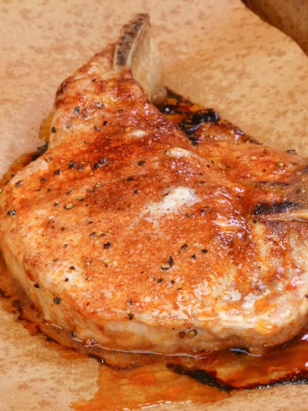 one baked bone in pork chop with homemade pork chop seasoning on a baking sheet.