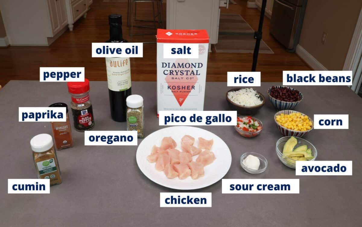 chicken burrito bowl ingredients assembled on a kitchen table.