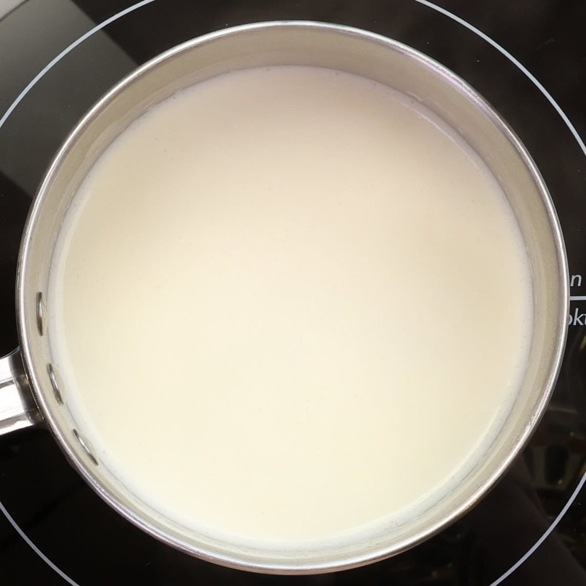 milk and cream heating on the stove for pot de creme.