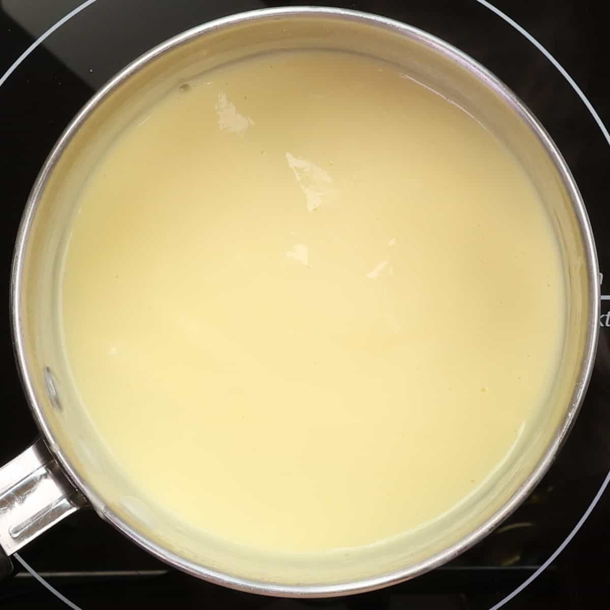 Custard thickening in a saucepan.