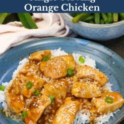 single serving orange chicken over white rice on a blue plate.