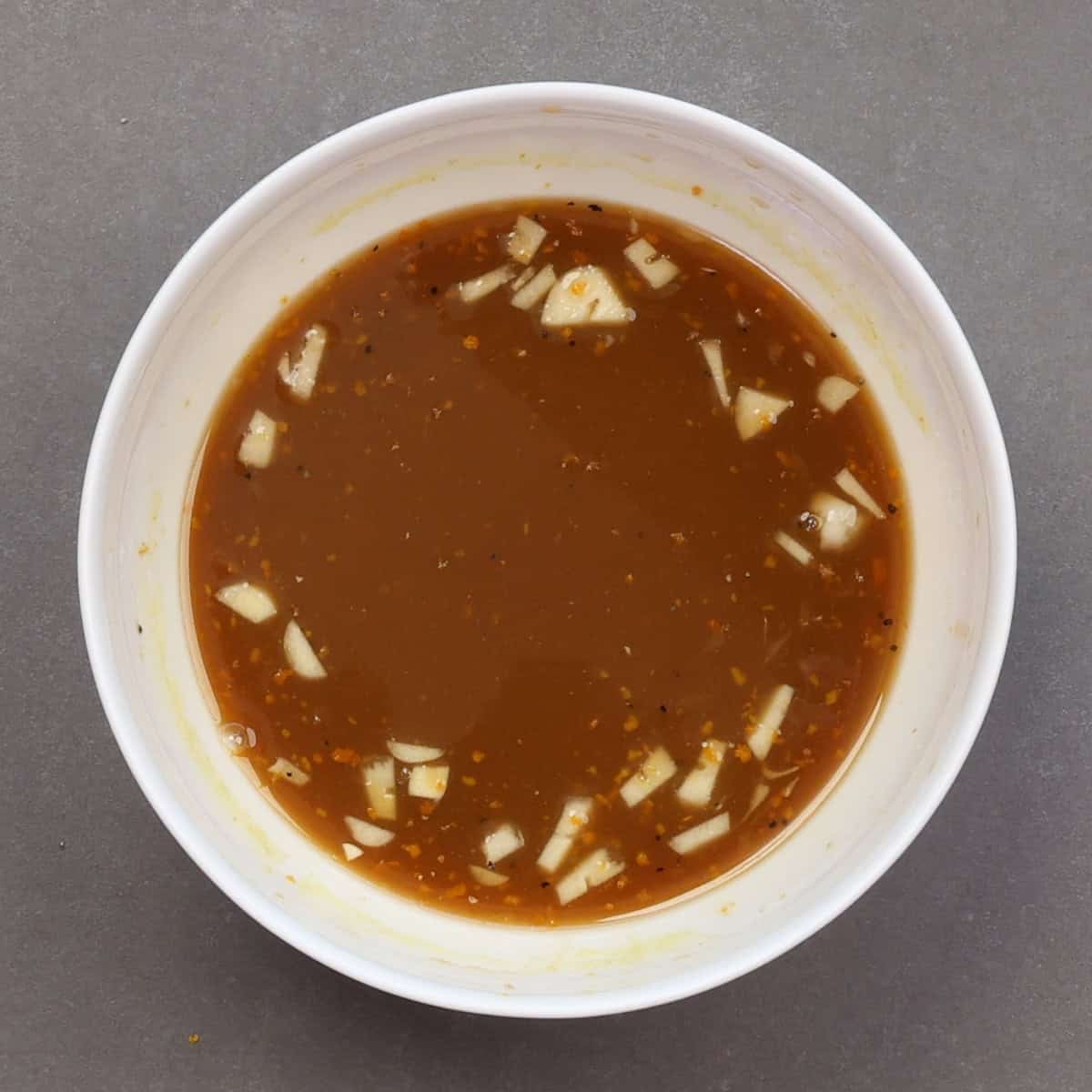 orange sauce for a single serving of orange chicken in a bowl.