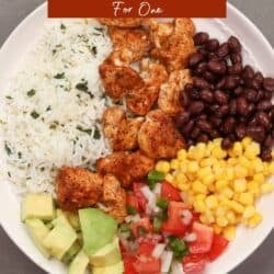 a single chicken burrito bowl with seasoned chicken, rice, black beans, corn, and avocado.