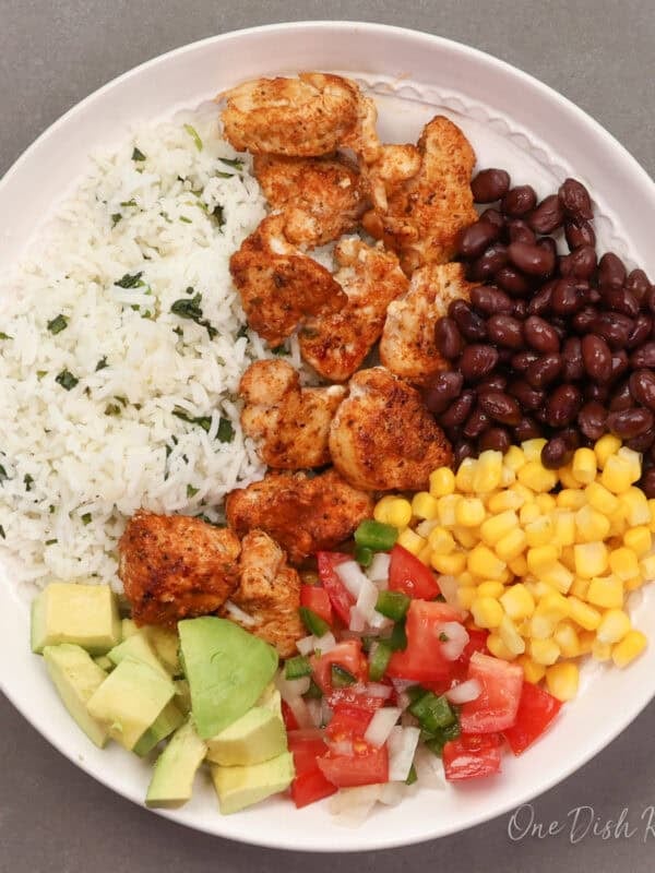 a single chicken burrito bowl with seasoned chicken, rice, black beans, corn, and avocado.