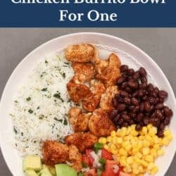 a single chicken burrito bowl with seasoned chicken, rice, black beans, corn, and avocado.